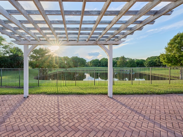 view of patio / terrace with a pergola and a water view