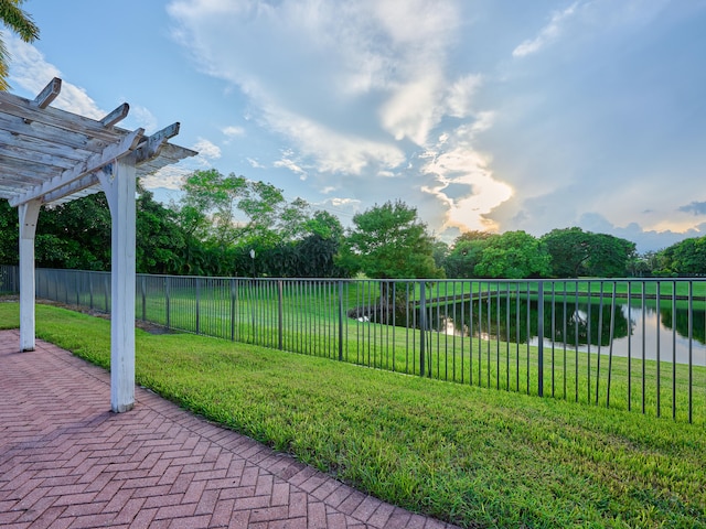 view of yard featuring a pergola and a water view