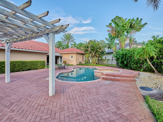 view of pool featuring a pergola, an in ground hot tub, and a patio