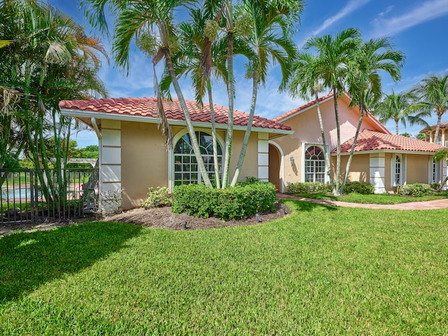 mediterranean / spanish-style house featuring a front lawn