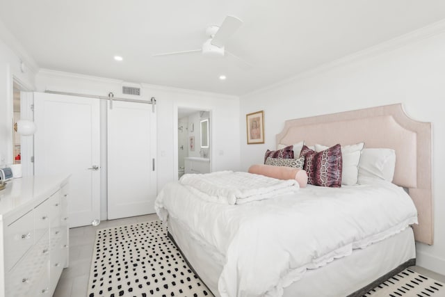 bedroom with a barn door, ensuite bathroom, ceiling fan, and ornamental molding