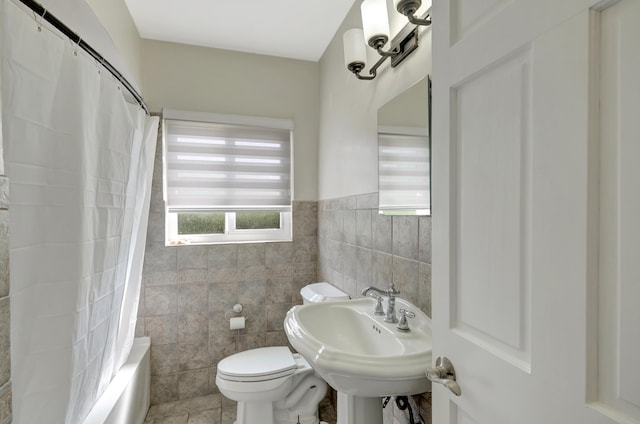 full bathroom featuring tile walls, sink, shower / bath combination with curtain, and toilet