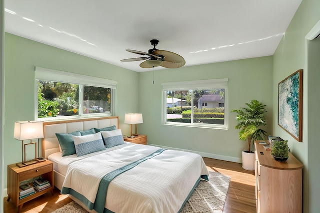 bedroom with ceiling fan and light wood-type flooring