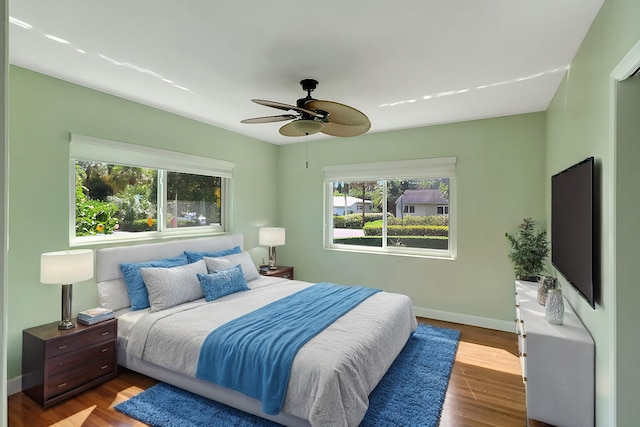 bedroom with hardwood / wood-style floors and ceiling fan