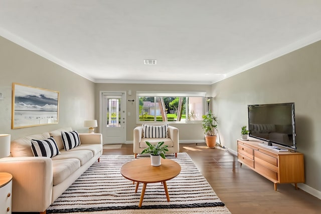 living room featuring crown molding and dark hardwood / wood-style flooring