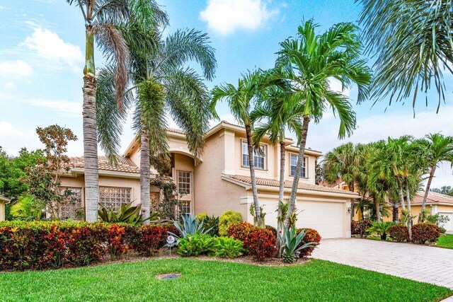 view of front of property featuring a lawn and a garage