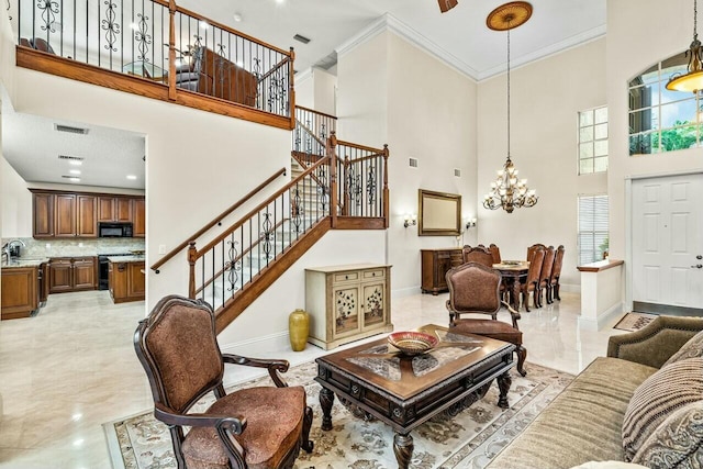 living room with a towering ceiling and ceiling fan