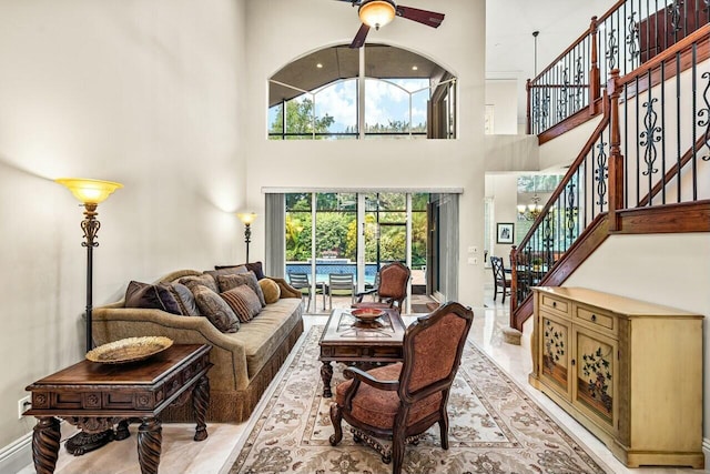 living room featuring a high ceiling, crown molding, and an inviting chandelier