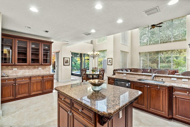 kitchen with light stone counters, decorative backsplash, beverage cooler, and a textured ceiling