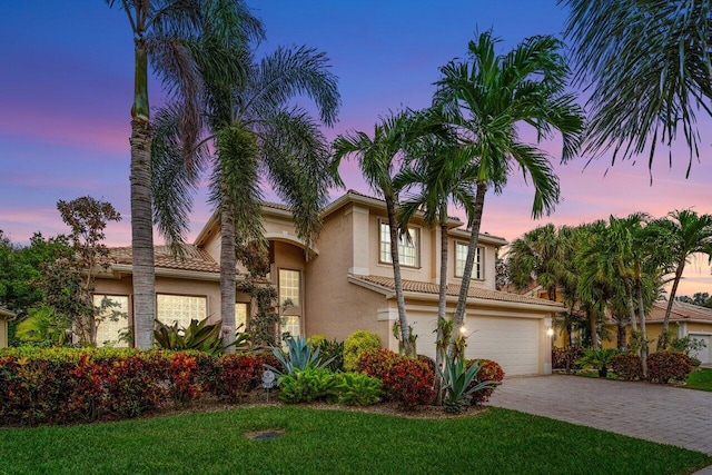 view of front of home featuring a garage and a yard