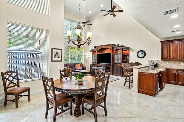 kitchen with stone countertops, stainless steel fridge with ice dispenser, a kitchen breakfast bar, a high ceiling, and kitchen peninsula