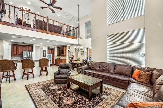 living room with ceiling fan with notable chandelier