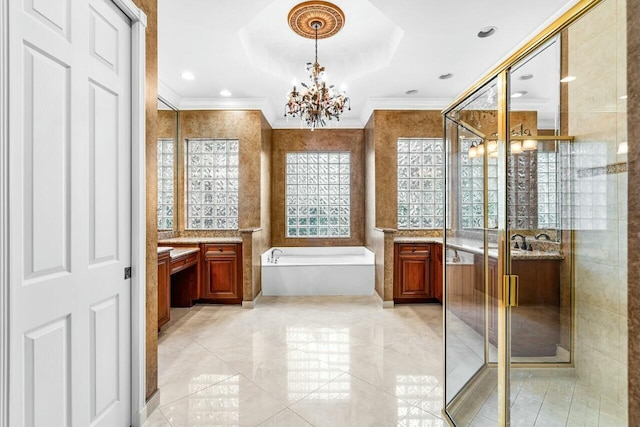 bathroom with a bathing tub, ornamental molding, vanity, and tile patterned floors