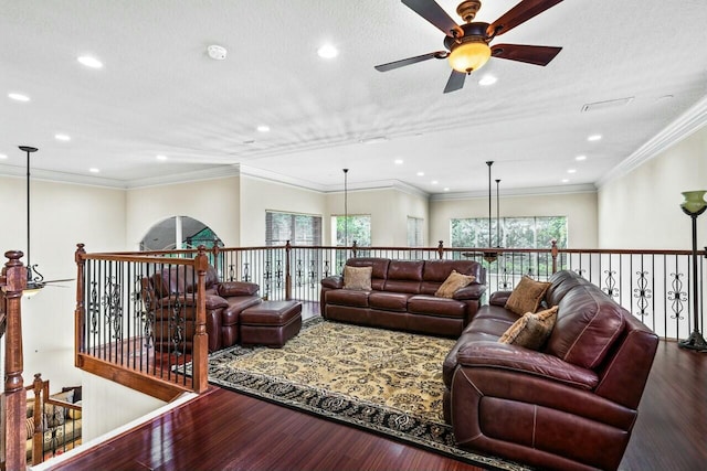 living room with ceiling fan, ornamental molding, hardwood / wood-style floors, and a textured ceiling