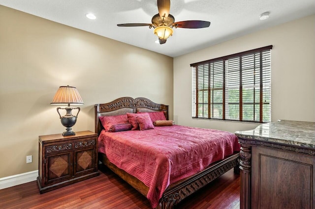 bedroom featuring ceiling fan and dark hardwood / wood-style floors