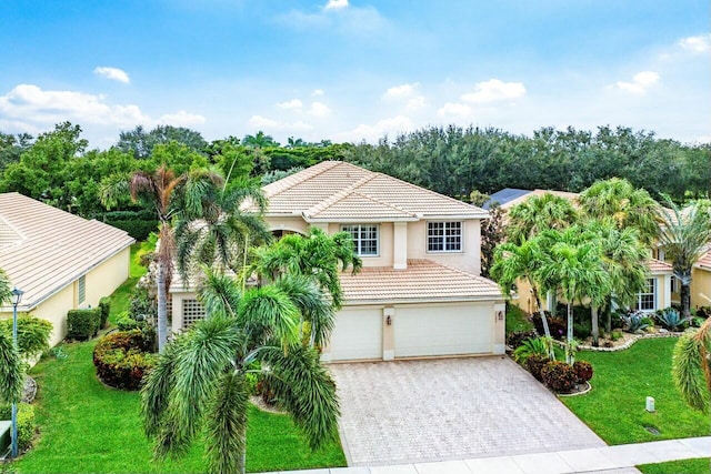 view of front of house with a garage and a front yard