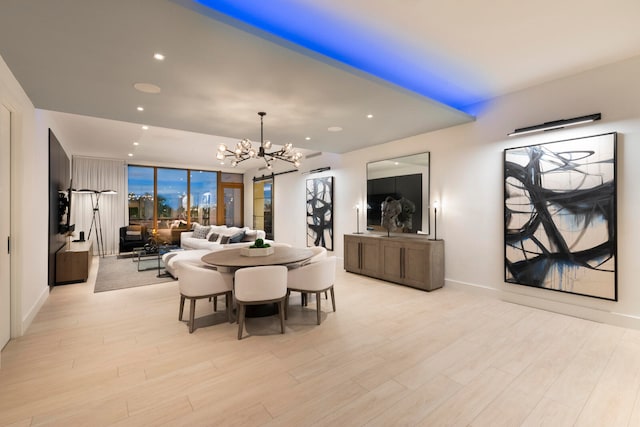 dining room featuring a chandelier and light hardwood / wood-style flooring