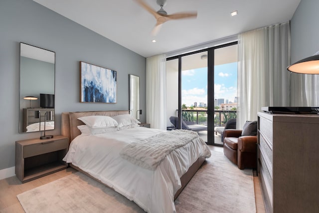 bedroom with access to outside, light hardwood / wood-style floors, a wall of windows, and ceiling fan