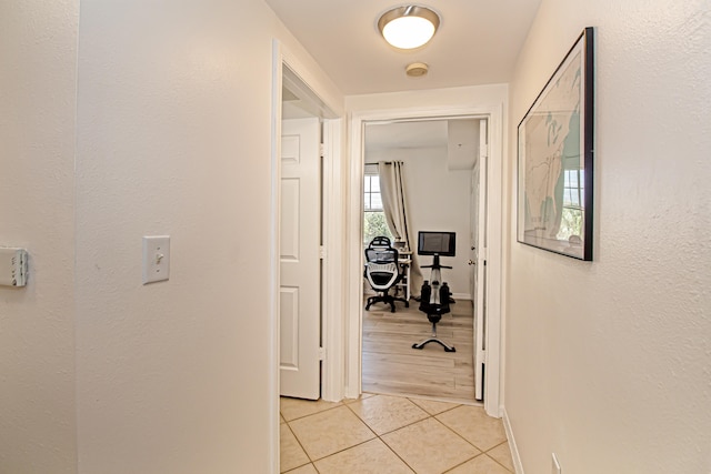 hall featuring light tile patterned flooring