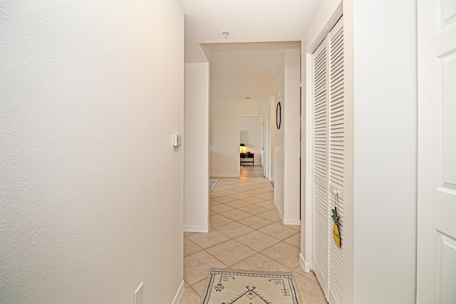 hall featuring light tile patterned flooring