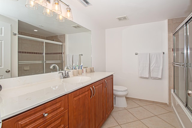 full bathroom featuring tile patterned floors, toilet, vanity, and enclosed tub / shower combo