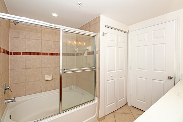 bathroom with enclosed tub / shower combo, vanity, and tile patterned floors