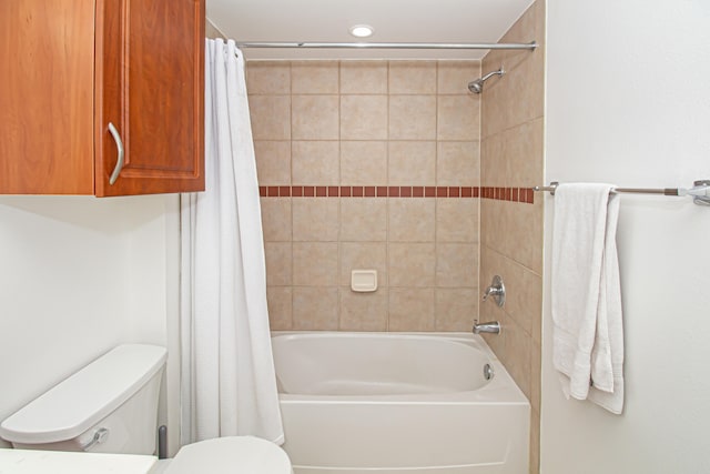 bathroom with toilet and shower / bathtub combination with curtain