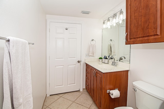 bathroom with vanity, toilet, and tile patterned floors