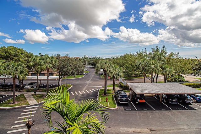 view of parking / parking lot featuring a carport