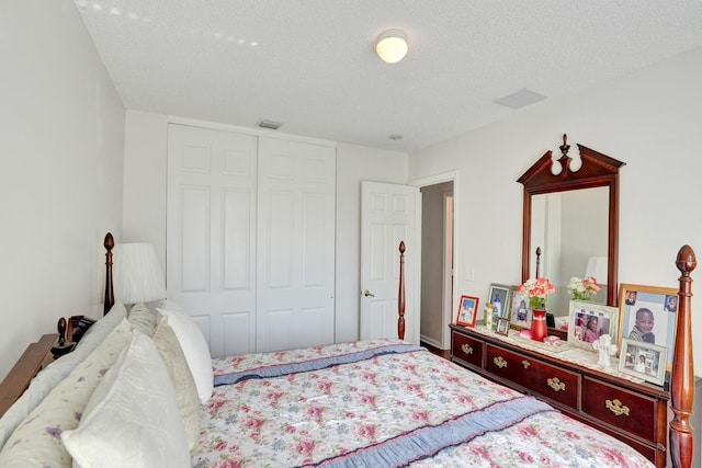 bedroom with a textured ceiling and a closet