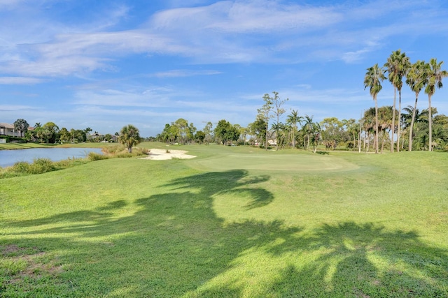 view of home's community featuring a water view and a yard