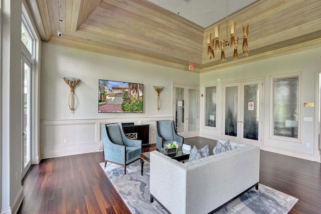 living room with wooden ceiling, a high ceiling, dark hardwood / wood-style flooring, and french doors