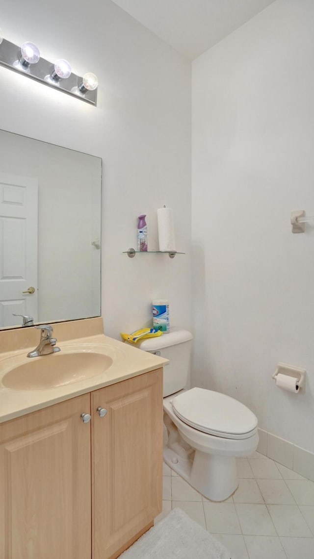 bathroom with vanity, toilet, and tile patterned floors