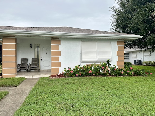 exterior space with a lawn and central AC