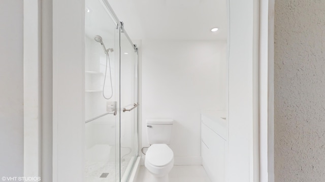 bathroom with walk in shower, vanity, toilet, and tile patterned floors