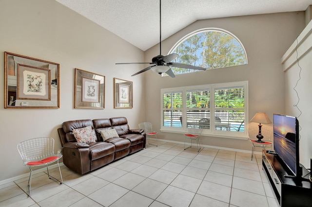 living room featuring a textured ceiling, high vaulted ceiling, light tile patterned floors, and ceiling fan