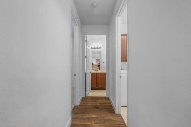 hall featuring sink and dark hardwood / wood-style flooring