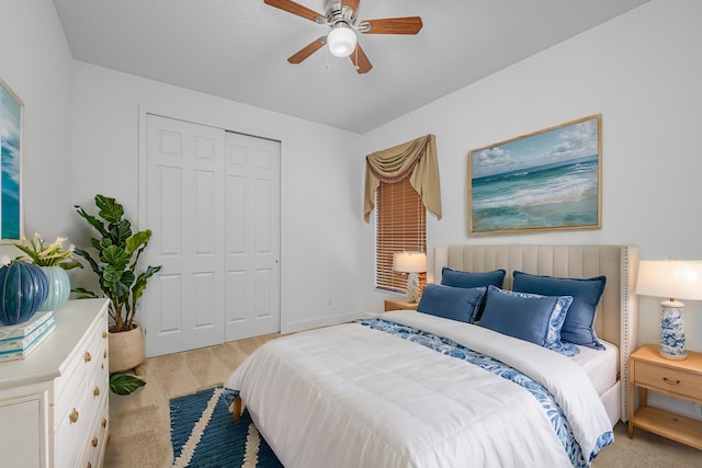 carpeted bedroom with a closet and ceiling fan