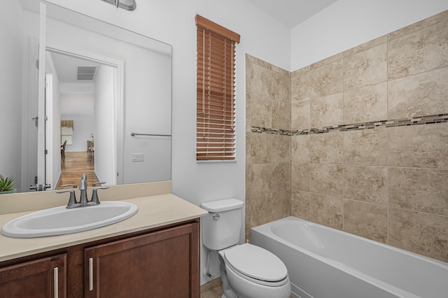 full bathroom featuring vanity, toilet, and  shower combination