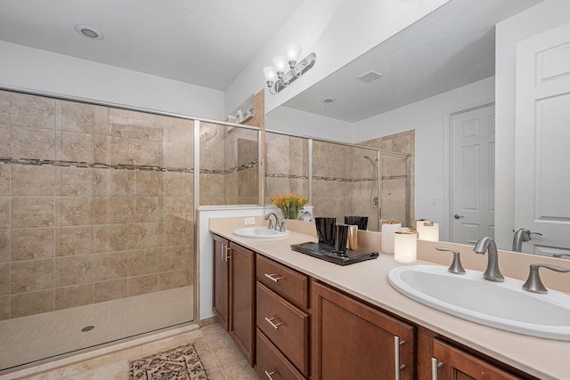 bathroom with vanity, tile patterned floors, and walk in shower