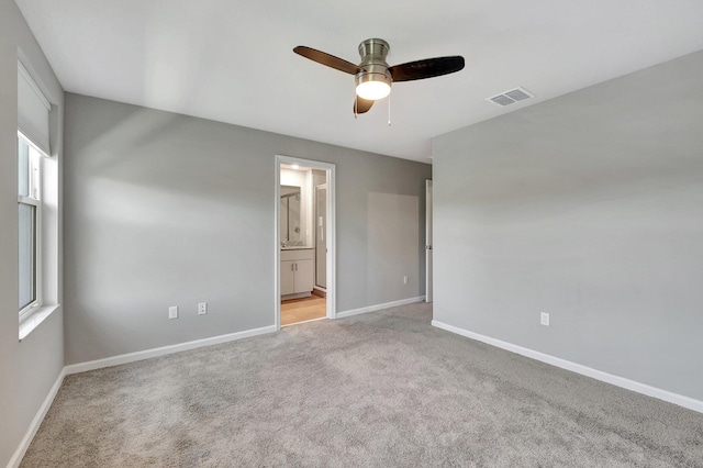 spare room featuring light carpet and ceiling fan