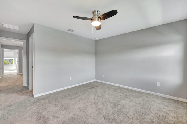 carpeted empty room featuring ceiling fan