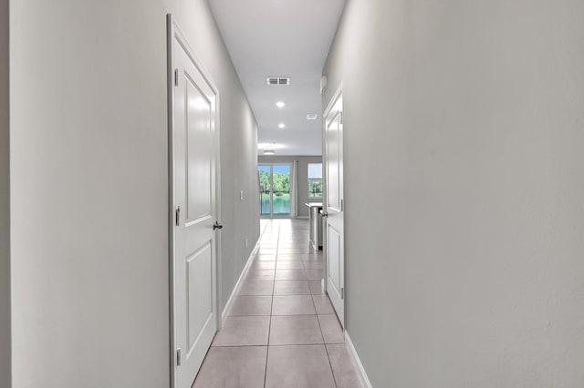 hall featuring light tile patterned floors