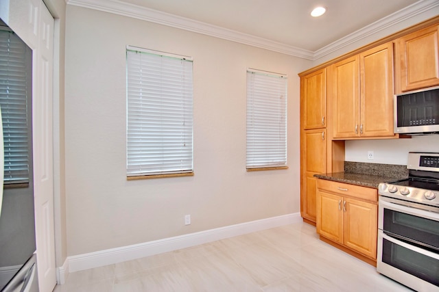 kitchen featuring ornamental molding, light brown cabinets, appliances with stainless steel finishes, and dark stone countertops