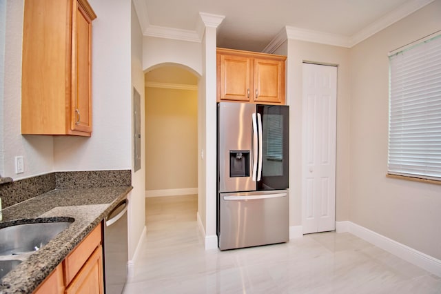 kitchen with light brown cabinets, sink, ornamental molding, dark stone counters, and appliances with stainless steel finishes