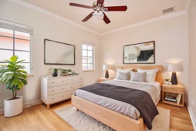 bedroom featuring ornamental molding, light wood-type flooring, and ceiling fan