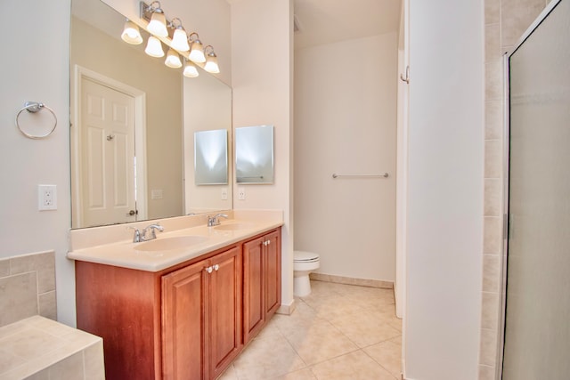 bathroom with vanity, tile patterned flooring, toilet, and a shower with shower door