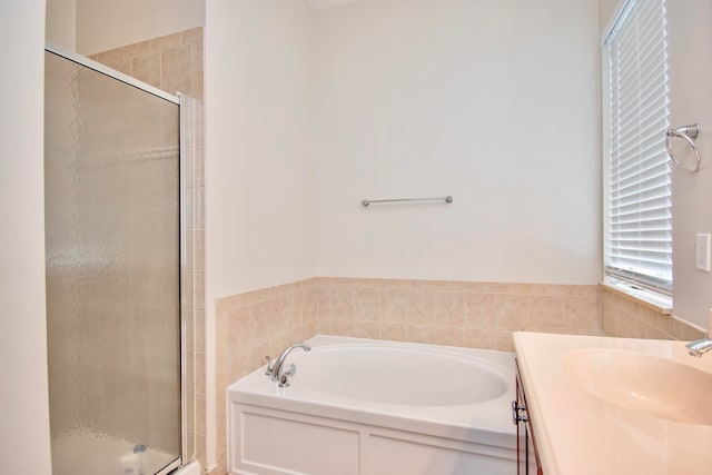 bathroom featuring shower with separate bathtub and vanity