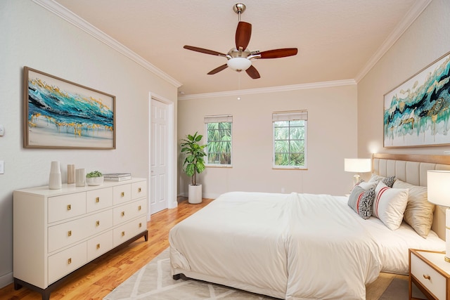 bedroom featuring ceiling fan, light hardwood / wood-style flooring, and crown molding