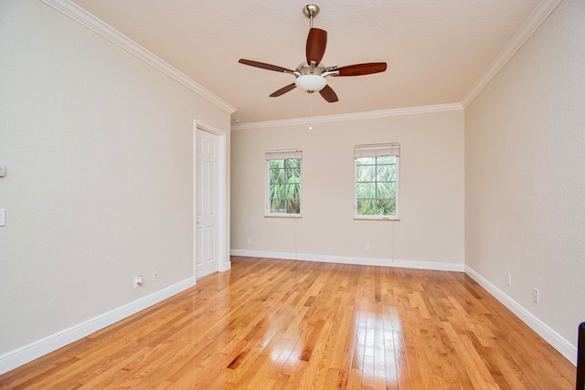 empty room featuring crown molding, light wood-type flooring, and ceiling fan